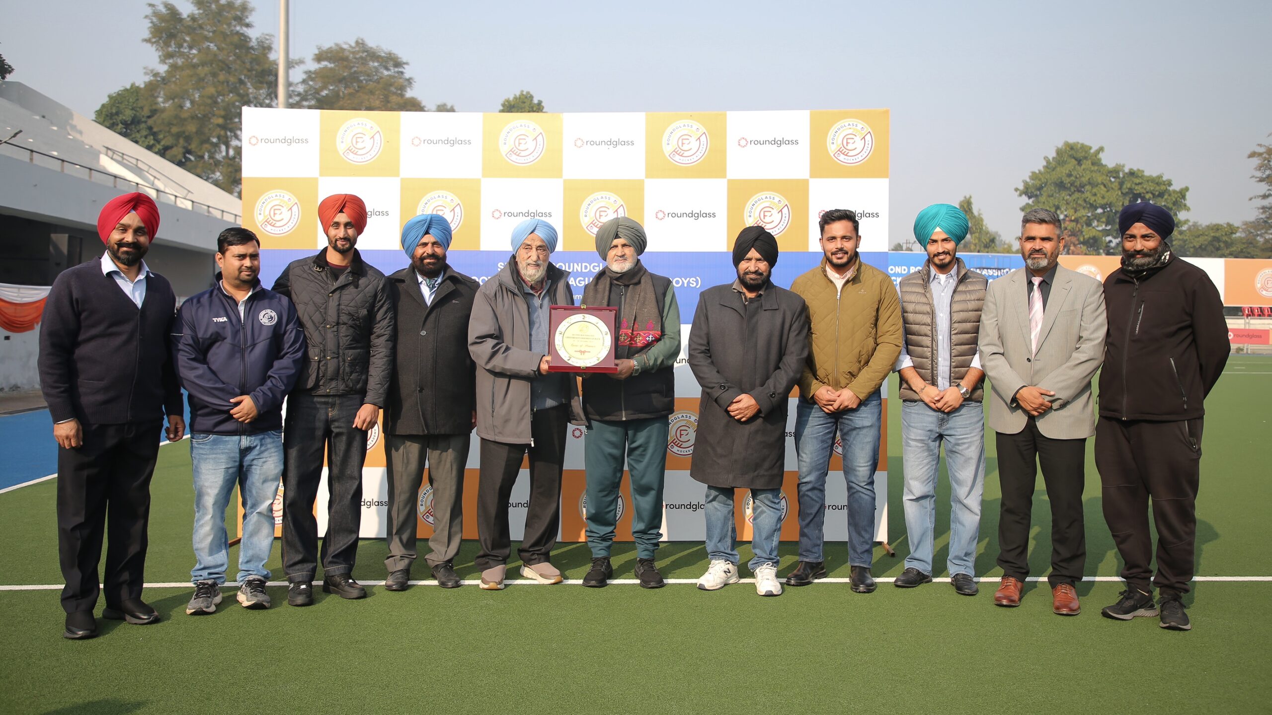 Olympian Harcharan Singh Brigadier (1975 World Cup winner) was honored by Round Glass founder Sarpal Singh. At that time he was accompanied by Olympian Harbinder Singh, Olympian Harmanpreet Singh, Olympian Mandeep Singh, Olympian Dilpreet Singh, Olympian Rajinder Singh Sr. and other administrators.