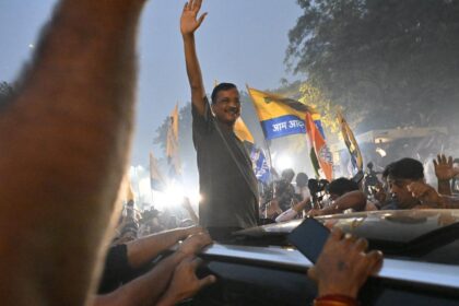 Delhi CM Arvind Kejriwal waves to party workers after leaving Tihar Jail in New Delhi.